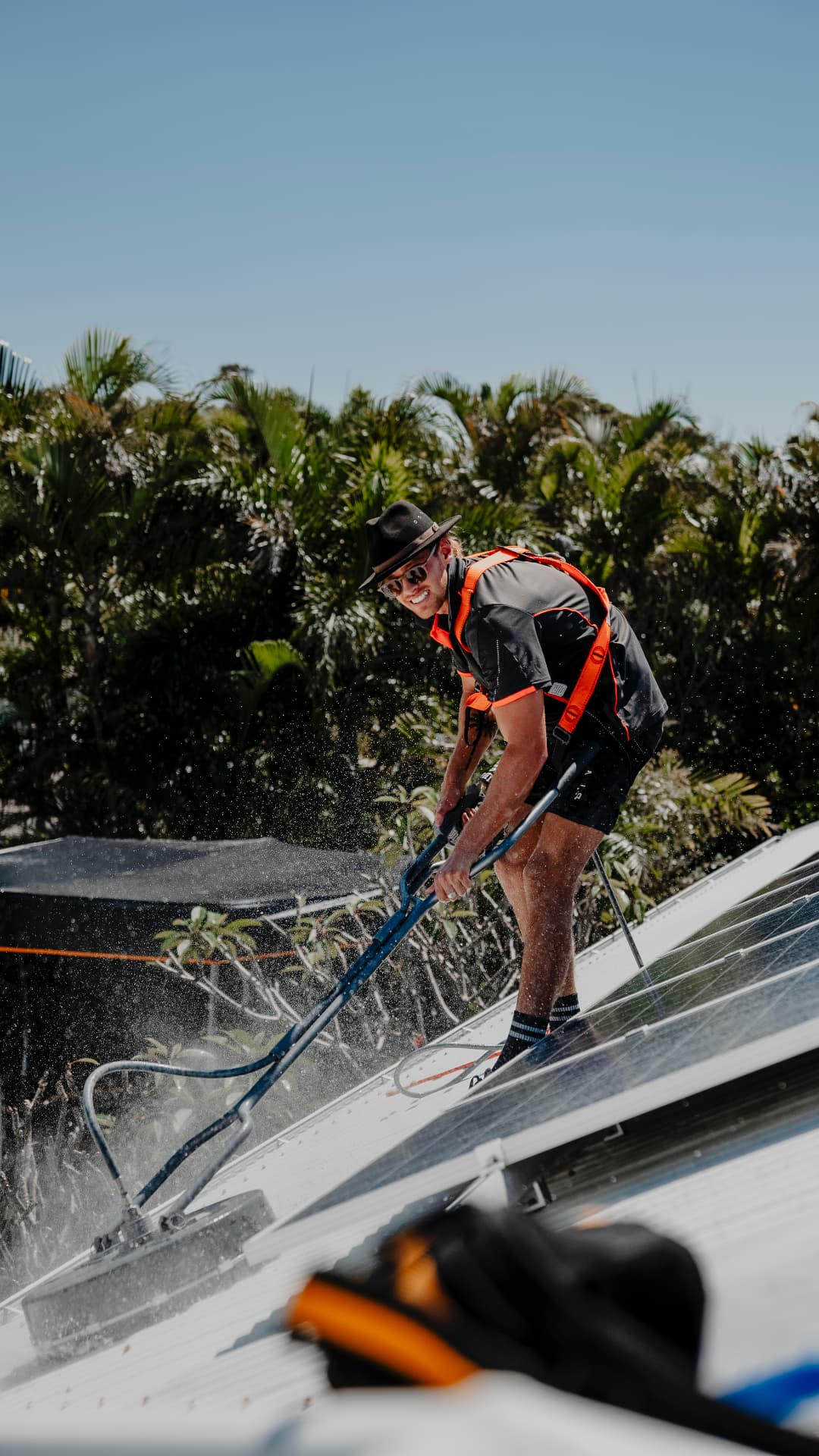 Soft washing a roof beside solar panels
